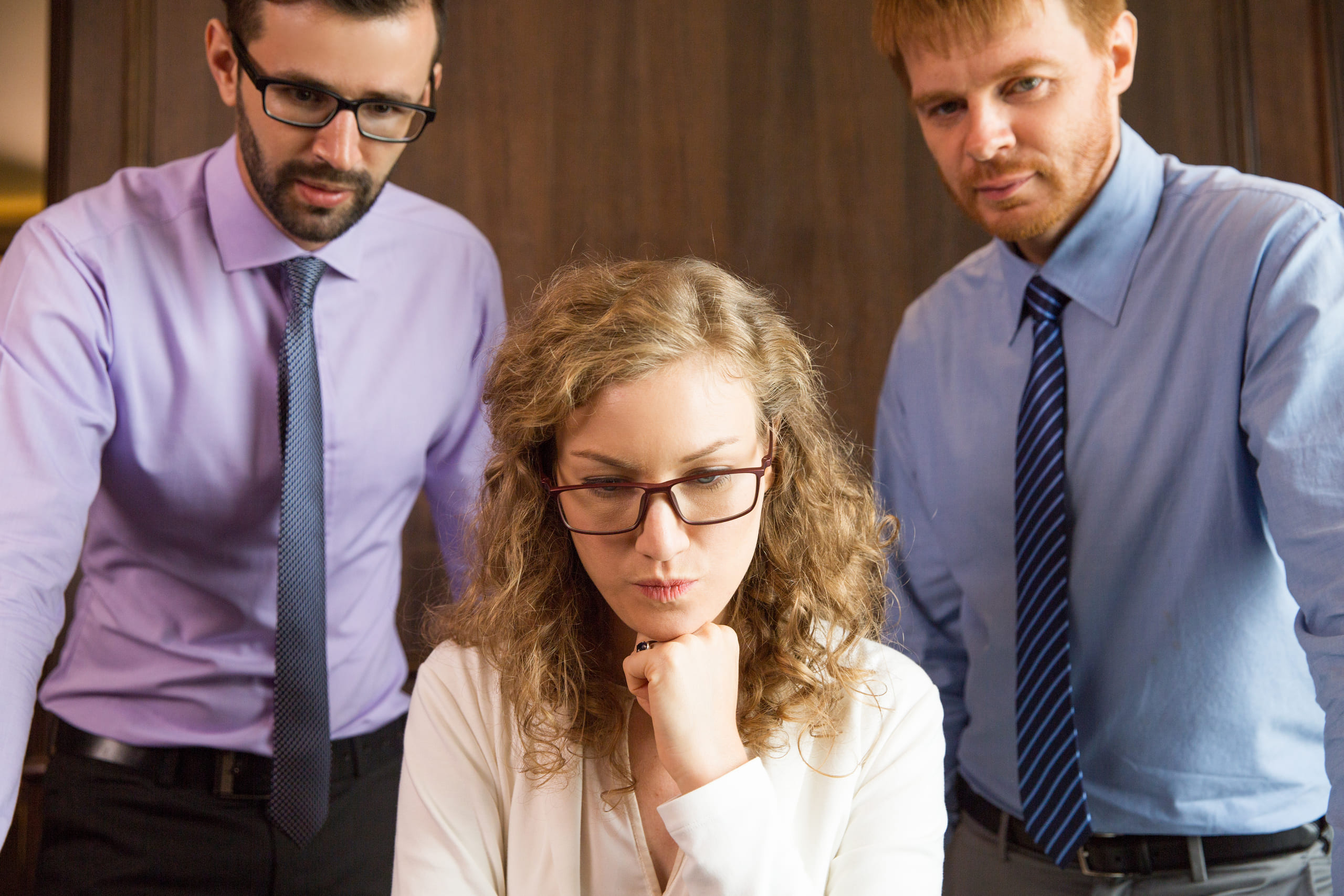 pensive-woman-looking-down-with-two-men